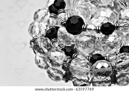 Jewelry made of silver and beads in black and silver on a silver background