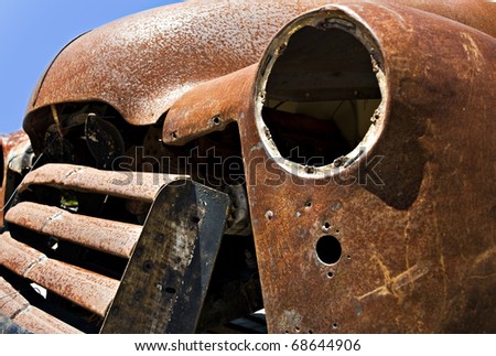 Old abandoned rusted truck - close up abstract with focus on the inside of the empty headlamp