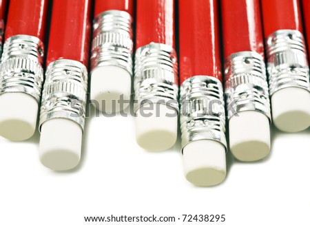 Close up macro of red pencils with white erasers on a white background with space for text