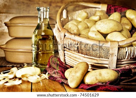 Still life of potatoes in a basket with olive oil - intentional low light and shallow depth of field