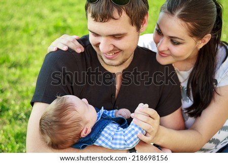 happy young family with baby in the park