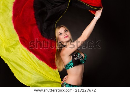 Beautiful bellydancer performing oriental dance in traditional costume