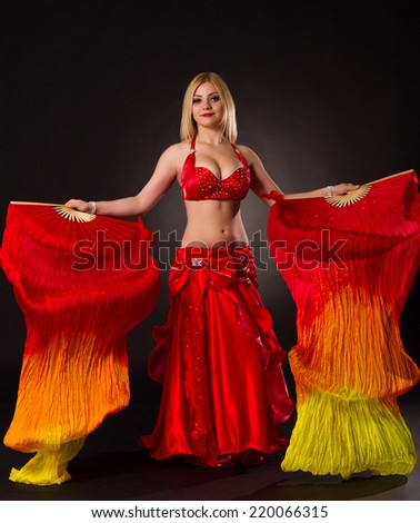 Beautiful bellydancer performing oriental dance in traditional costume