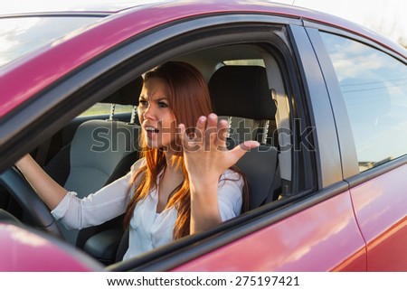Portrait of unhappy, crying girl driving a car