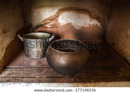 Old dishes on the old furnace. Vintage toning