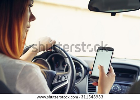 Woman working at the wheel in the car. don\'t text and drive