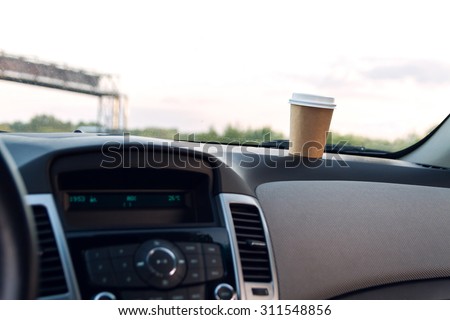 A cup of coffee on the console car