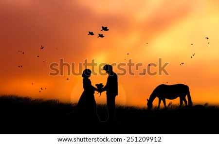 Silhouette human in love up over blurred on sunset nature background.