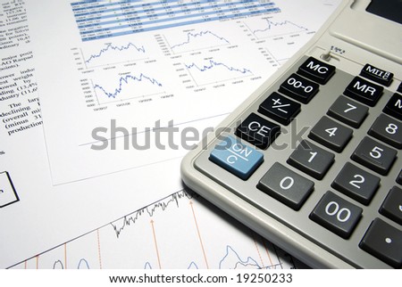 Calculator and financial data with graphs. Business concept.
