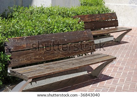 Two empty wooden benches near church in Lloret de Mar.