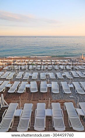 Lot of deck-chairs at the beach of city of Nice, France, Cote d\'Azur.