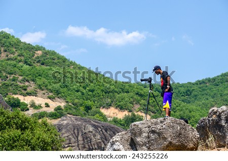 METEORS, GREECE - AUGUST 11, 2014: Unidentified man photographs the landscape in Meteors, Greece