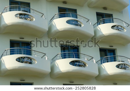 NEA KALLIKRATIA, GREECE - AUGUST 8, 2014: White open balconies of the Aegean Blue Beach Hotel 4*  (small modern hotel opened in 2010) in the popular picturesque resort town Nea Kallikratia, Greece
