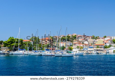 SITHONIA, GREECE - AUGUST 16, 2014: Yachts near pier of resort town Neos Marmaras, Sithonia, Greece