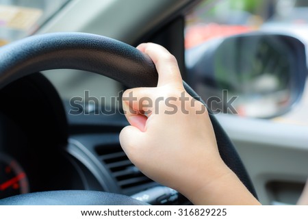 Unsafe hand on the steering wheel during on driving