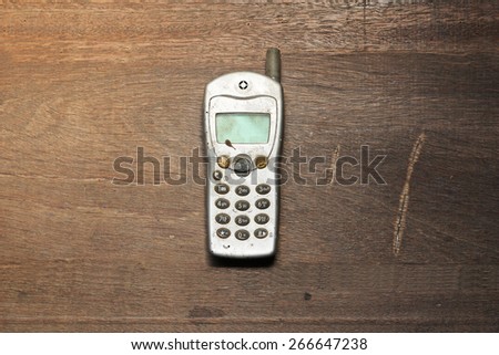 old mobile phone on wooden table