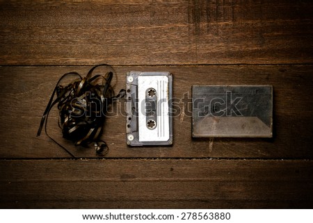 Old Cassette tape on wooden table  (vintage color tone)