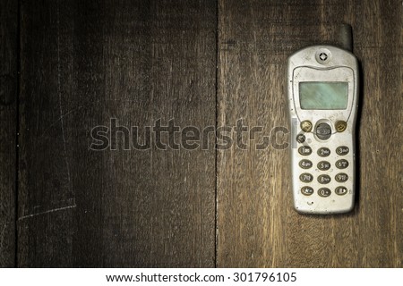 old mobile phone on wooden table