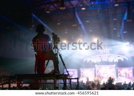 Camera man is making video of evening concert