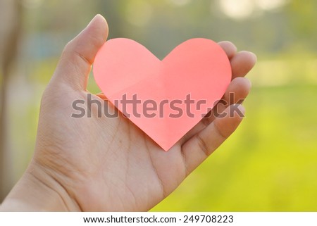 pink heart and hand valentines day background.