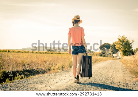 Girl is walking with her suitcase during her holiday - people, holidays and lifestyle concept