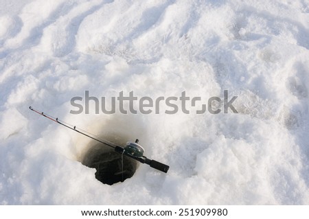a fishing rod on the ice