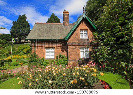 Little house with roses in the garden