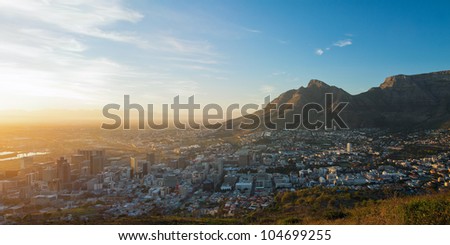 Summer panorama of dawn in the city on the background of the mountains (Cape Town, South Africa - Table Mountain)