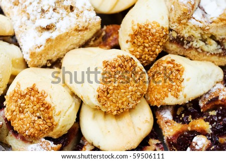 background of sweets - cookies and cakes with sesame seeds and raisins