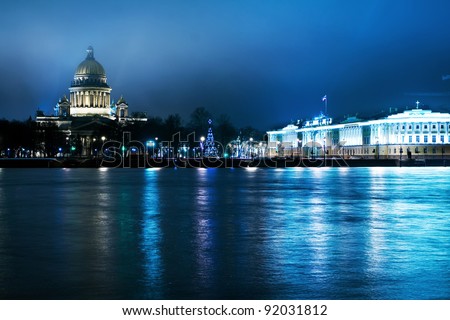 Panorama of the city at night (St. Petersburg), which is reflected in the river (Neva River), Russia