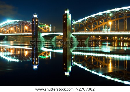 Night Bridge in the spotlight across the Neva River (St. Petersburg, Russia Peter the Great Bridge)