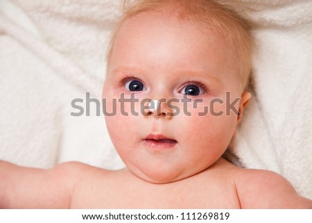Mother creaming cute infant girl face
