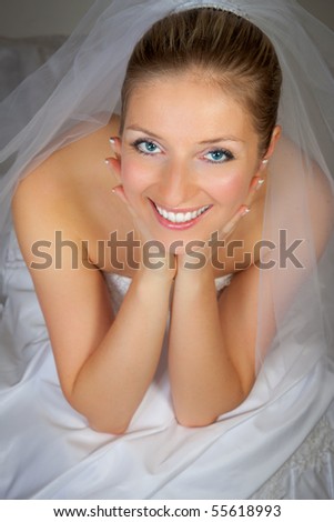 stock photo Young woman in wedding dress in studio