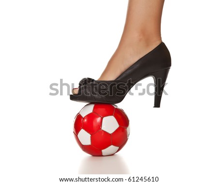 Caucasian blond business woman leg in high heel with soccer ball