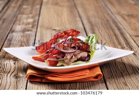 Shish kebab with crispy rashers of bacon and vegetables
