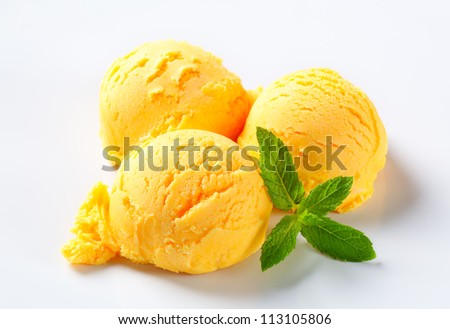 Scoops of yellow ice cream with mint