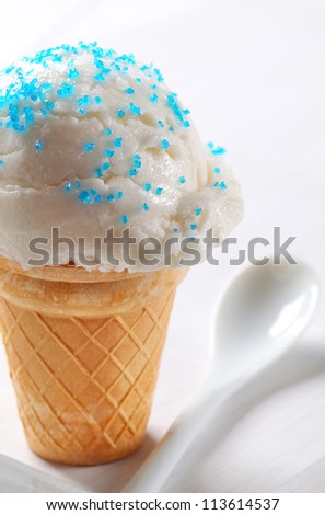 Lemon ice cream cone topped with sprinkles