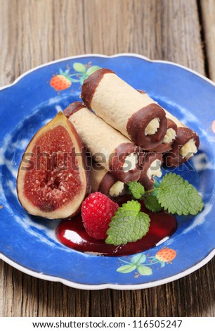 Cream filled rolls garnished with fruit and coulis