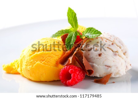 Scoops of ice cream with chocolate curls and fruit