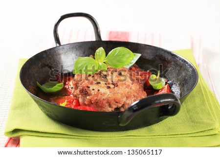 Pan fried meat patty in a black pan