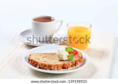 Breakfast with cup of coffee, juice and bread with cheese