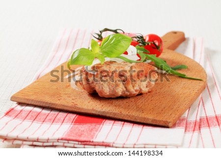 Meat patty on a cutting board