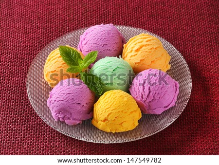 Group of ice cream scoops on a scarlet cloth