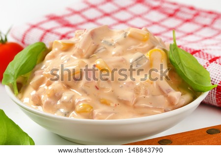 Potato ham salad dressed with mayonnaise in a bowl