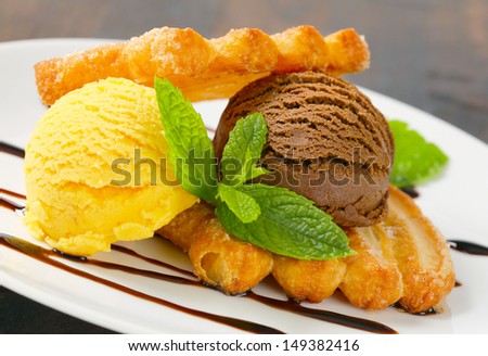 Puff pastry cookie with scoops of vanilla and chocolate ice cream