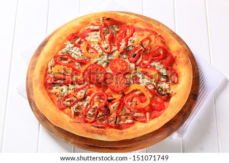 Vegetable pizza on white cutting board