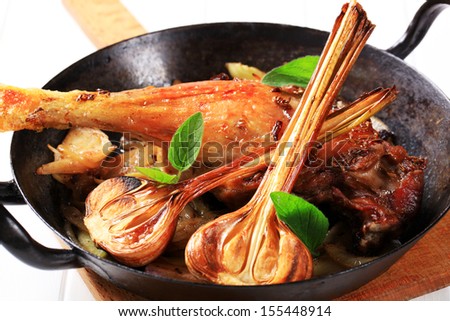 Roasted duck leg with garlic in a casserolle