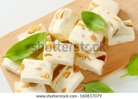Soft nougats with peanuts and fruits on a cutting board
