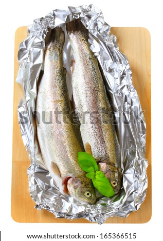 Two fresh trout on tin foil - cutout