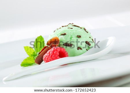 Scoops of pistachio ice cream with raspberry and chocolate curls